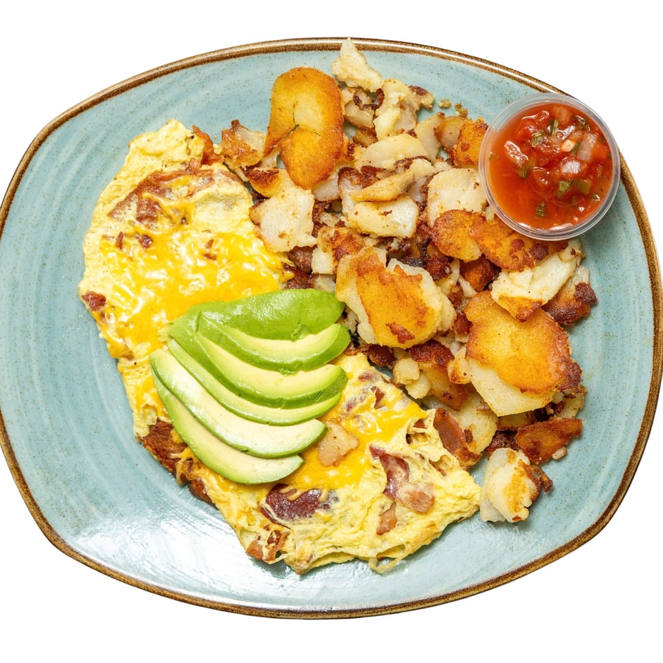 Omelet with melted cheese and avocado slices, served with crispy home fries and a side of salsa.
